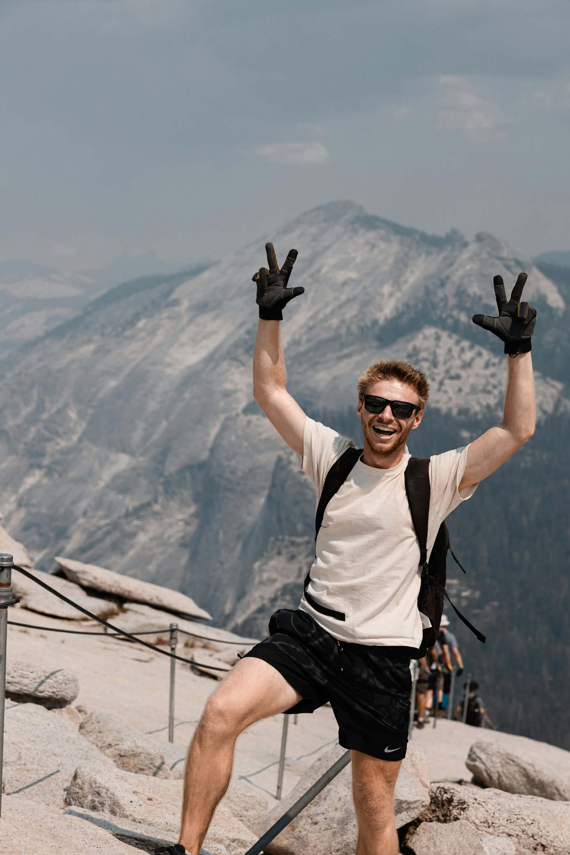 Happy hiker at mountain summit